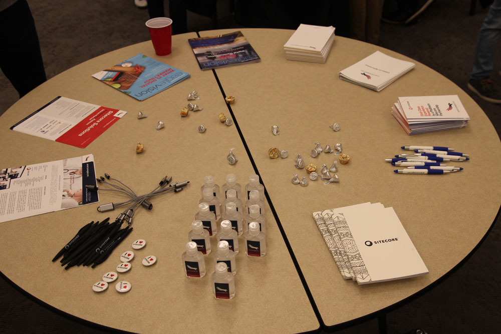 Table full of Sitecore swag.